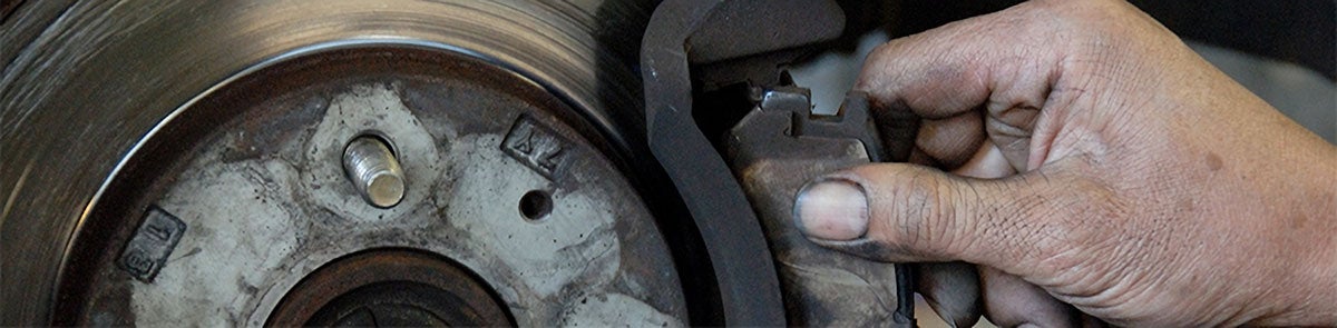 Mechanic Hand Checking Vehicle Brake